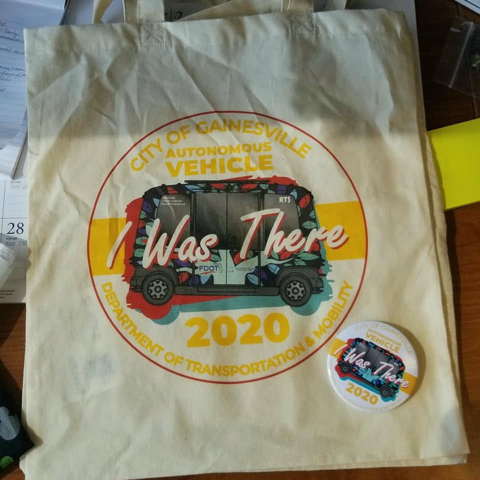 Autonomous vehicle open house reusable bag and pinback button display
